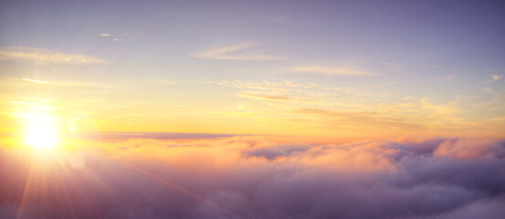 Wall Mural - Panoramic view above clouds with beautiful sunset.