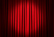 © New Africa - Spotlight illuminating closed red stage curtains. Start of performance