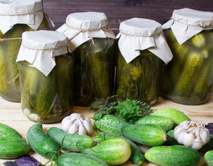 Wall Mural - jars of pickled cucumbers on wooden background