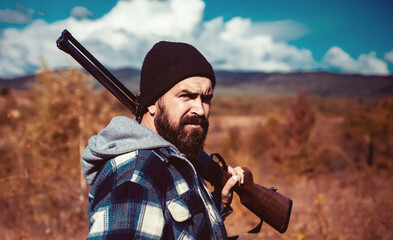 Wall Mural - Hunter with shotgun on hunt. Hunting. Closed and open hunting season. Hunting is the practice of killing or trapping animals. Gun rifle.