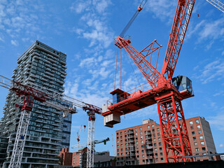 construction site with multiple cranes for construction of a new high rise apartment building