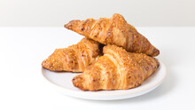 White Plate With Three Tasty Croissants On White Background. French Food