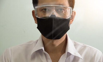 Businessman wearing safety google and mask to protect virus COVID-19. Stay home, Work from home, Social Distance Concept.