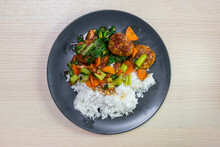 A Plate Of Meatball And Vegetable Stir Fried With Steam Rice.