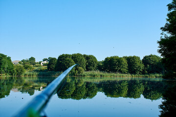 Fishing rods and spinnings in the composition with accessories for fishing on the river