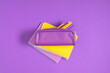 Purple pencil case with pencils and notebooks on purple background. Back to school. Flat lay, top view, copy space