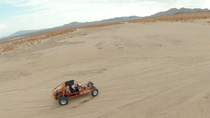 Wall Mural - Dune Buggy Driving in the Desert Sand Dunes