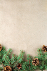 Sticker - Border of fir tree branch with cones on craft paper for christmas card with copy space for text. Top view, flat lay