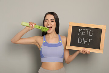 Canvas Print - Happy woman holding celery and chalkboard with words Keto Diet on light grey background