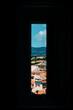 View from inside  to the sunny Cascais city in Portugal through a narrow window