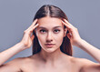 © Olena Apetroaiei - Beautiful young woman with clean perfect skin. Portrait of beauty model with natural nude makeup. Spa, skin care and wellness. Close up, gray background, copyspace.