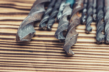 old metal drills on wood backgrounds