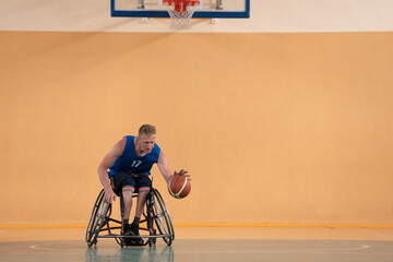 disabled war veterans in action while playing basketball on a basketball court with professional sports equipment for the disabled