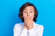 © deagreez - Photo of pretty shocked school boy wear formal outfit smiling arms cover lips isolated blue color background