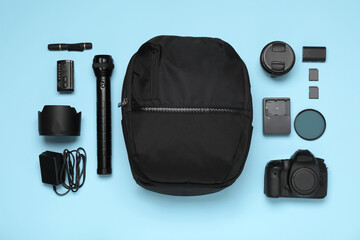 Wall Mural - professional photography equipment and backpack on turquoise background, flat lay