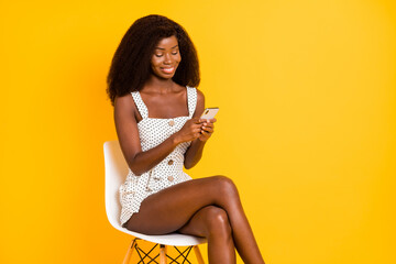 Poster - Photo of nice optimistic cute brunette lady sit write telephone wear white dress isolated on vivid yellow background