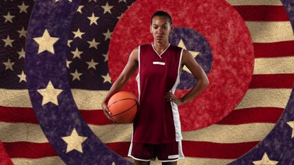 Canvas Print - Female basketball player holding a ball against stars on spinning circles and waving american flag