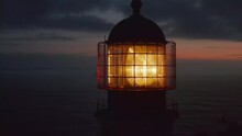 Close Up Of Lighthouse Shining Head Fresnel Lens At Dusk, Drone Circling Around Reveals Sensational Evening Sea Panorama, Lagos, Portugal