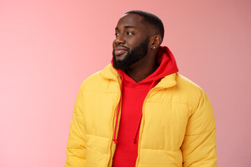 Dreamy happy optimistic black bearded man looking left daydreaming recalling nice moments, enjoying warm peaceful weather walking park feel calm relieved, standing pink background smiling cute