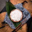 Shirataki rice or noodles on wooden table background. Konnyaku from konjac yam for wok. Healthy japanese diet. Gluten free and carbs free KETO food. Traditional oriental style. Square, close up