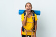 © luismolinero - Young mountaineer woman with a big backpack isolated on white background shouting with mouth wide open