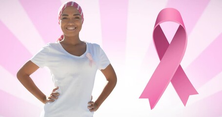 Wall Mural - Animation of pink breast cancer ribbon logo over smiling woman