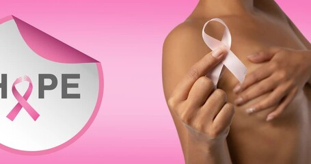 Wall Mural - Animation of pink ribbon logo with hope text over woman covering the breast