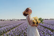 © Cavan Images - Full length portrait of woman standing on hyacinth fields