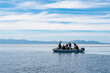 © Cavan Images - divers heading to dive spot on dingy boat in Raja Ampat