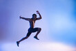 © Cavan Images - Black sportsman jumping in studio