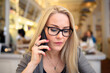 © Cavan Images - Adult blond woman speaking on phone