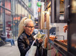 © Cavan Images - Young woman buying food in street truck