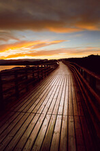 Wooden Bridge In The Sea With The Sunset