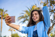 © Cavan Images - Student girl using technology at garden