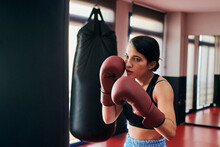 Woman Trains With A Punching Bag In A Muay Thai Gym