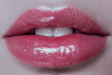 Part of face,young woman close up. plump glossy lips