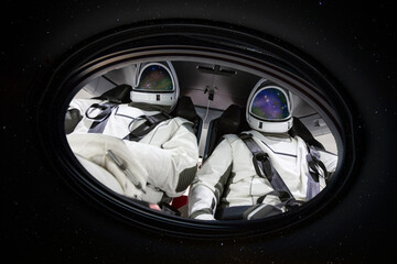 Wall Mural - two astronauts in porthole in space. elements of this image furnished by nasa.