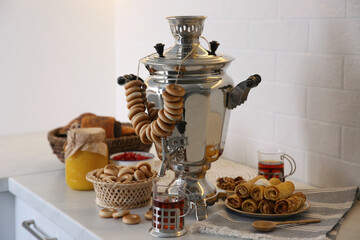 Wall Mural - Traditional Russian samovar with treats on white table