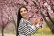 © New Africa - Pretty young woman near blooming tree in park. Spring look