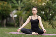 © EduLife Photos - A confident middle-aged Asian woman in sports outfit doing yoga exercise on the yoga mat outdoor in the backyard in the morning. Young woman doing yoga exercise outdoor in nature public park