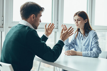 Poster - business man and woman at the table communication to work colleague