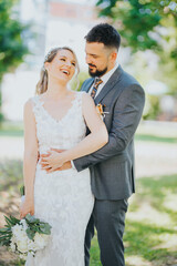 Canvas Print - Happy Bosnian couple on a wedding photoshoot in the summer park