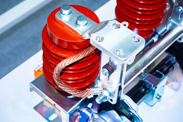 Red current transformers. Two current transformers close-up. Abstract equipment mechanism with a transformer. Fragment of electrical equipment. Close-up of a copper wire transformer.