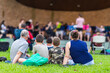 © Austockphoto - family watching band performance at park