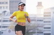 © EduLife Photos - A young Asian woman athlete runner jogging on running track in city stadium in the sunny morning to keep fitness and healthy lifestyle. Young fitness woman runs on stadium track. Sport and recreation