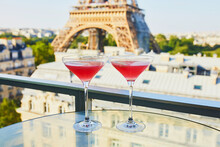 Two Cosmopolitan Cocktails In Traditional Martini Glasses With View To The Eiffel Tower, Paris, France