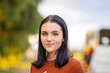 © Austockphoto - head and shoulders of dark haired teenage girl looking at camera