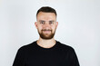 © Мар'ян Філь - Portrait of a young man with a short beard on a light background, he is smiling, he is in a good mood, the guy waited a long time until the beard grows