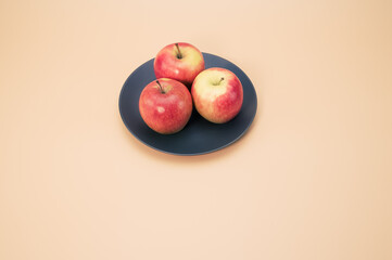 Sticker - Top view of apples on a plate isolated on light cream background