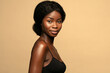 © Beauty Agent Studio - Beautiful african american woman with curly hair against beige background